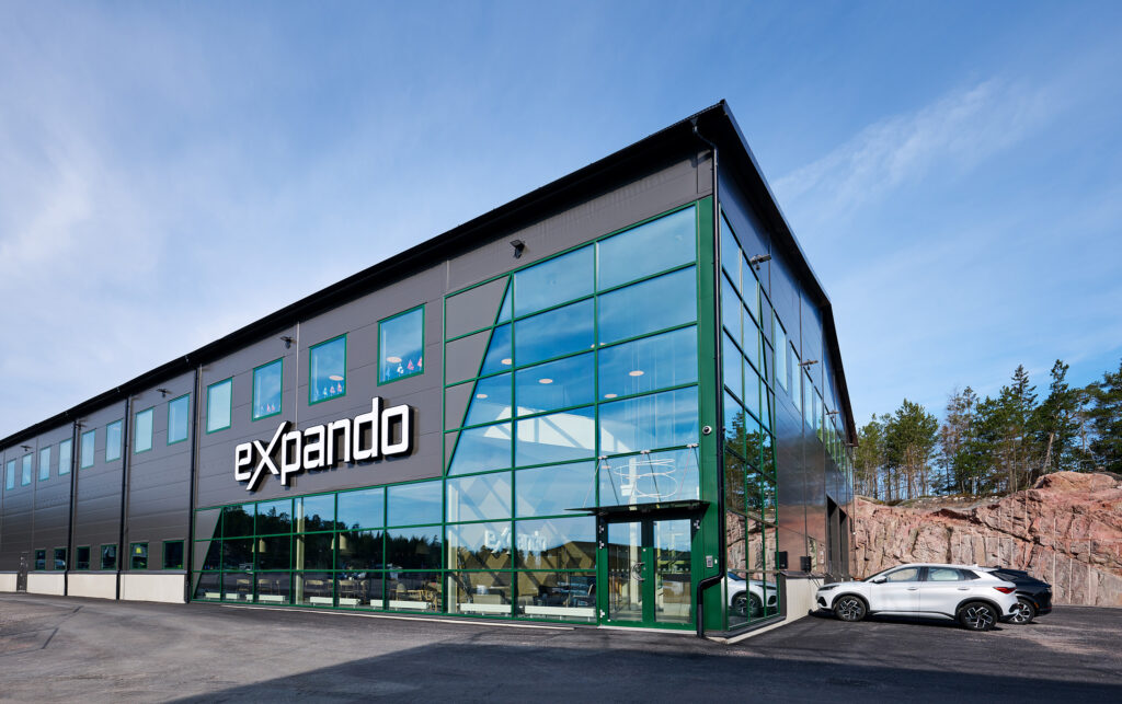 office building with green details and blus skies